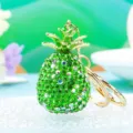 Close up detail shot of a sparkling green crystal rhinestone pineapple metal keychain. - Single OPP Bag Packaging / Green