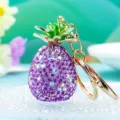 Close-up of sparkling purple rhinestone pineapple keychain pendant with gold hardware details. - Single OPP Bag Packaging / Purple