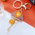Cute sunflower rhinestone handbag keychain, golden metal ring and pearl charm for bags. - Pink