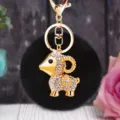 Detailed view of the cute plush ram keychain with rhinestones and black pom pom. - Lucky White Sheep + Black Plush Ball