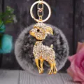 Close-up of the sparkling rhinestone goat keychain with fluffy gray plush ball and gold hook. - White Goat with Frost Green Plush Ball