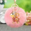 Cute plush sheep keychain with rhinestone metal ram pendant and fluffy pom pom bag charm detail. - Lucky Pink Sheep + Pink Plush Ball