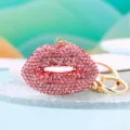 Close-up view of the sparkling pink rhinestone lip keychain, showcasing crystal details and gold hardware. - Pink