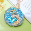 Closeup detail of sparkling blue rhinestone butterfly dragonfly portable pocket makeup mirror keychain. - Blue Butterfly B