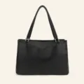 Black tote bag detail view showing multi-compartment interior and geometric panel stitching. - Black