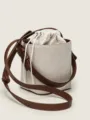 Detailed view of the canvas bucket bag showing textured fabric and brown leather straps. - 15.5*16*12cm / Cream