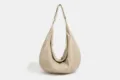 Detailed view showing the lightweight waterproof nylon dumpling shoulder bag design. - Khaki