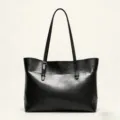 Black PU leather tote bag handle detail showing sleek design and fine stitching quality. - Black