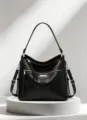 Black soft leather handbag detail, gold hardware, multi-zipper pockets, stylish shoulder bag. - Black