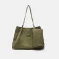 Green corduroy tote bag detail showing texture, chain strap, and attached mini pouch. - Green