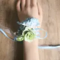 Forest style artificial flower wrist corsage with blue carnations and ribbons for wedding. - Wrist Corsage / Blue