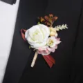 Detail shot of elegant artificial rose boutonniere pinned on black suit lapel for wedding. - Boutonniere Style B
