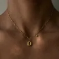 Close-up view of the 18k gold plated stainless steel wavy chain necklace with letter D pendant. - Letter D