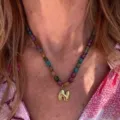 Colorful beaded necklace with gold letter pendant, fashion daily jewelry detail shot. - Letter N