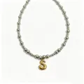 Stainless steel beaded chain necklace featuring a shiny gold bubble letter S pendant detail. - Letter S