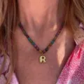Close-up detail of colorful beaded necklace with gold letter R pendant for women daily wear. - Letter R