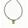Stainless steel beaded necklace detail featuring a gold puffy letter Z pendant design. - Letter Z