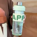Green plastic water bottle sports shaker cup with silicone sleeve and portable tea filter lid. - 650ml / Green