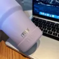 Tyeso purple stainless steel tumbler detail view with silicone protective boot on desk. - Diameter 71-75mm / Lilac Purple
