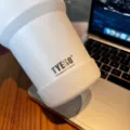 Detailed view of Tyeso insulated tumbler with silicone boot base, showing brand logo and texture. - Diameter 71-75mm / Snow White