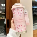 Pink stainless steel travel coffee mug with cherry blossom pattern and carry strap. - Sakura Pink