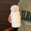 Portable stainless steel vacuum insulated water bottle, white dual-drink thermos with pink lid. - White
