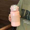 Portable stainless steel pink thermos bottle with straw and cup sleeve for office. - Pink