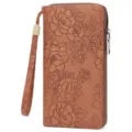 Detailed view of women long embossed floral wallet with zipper closure and wrist strap. - Print Brown