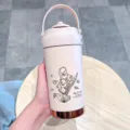 Pink stainless steel portable thermos cup with handle and lily flower print for daily use. - Pink