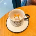 Cute ceramic coffee mug with 3D cat figurine inside, matching saucer set, white variant - Yellow Ear Cat