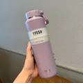 Purple 710ml vacuum insulated water bottle with portable lid, ideal for outdoor sports and use. - 24oz / Purple