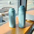 Large capacity stainless steel sports water bottle with portable lid and stylish blue finish. - Blue