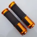 Close-up detail of aluminum alloy bicycle handlebar grips in vibrant orange and black. - Gold