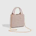 Close-up detail of luxury beaded floral embroidered pink handbag with gold chain strap. - Khaki