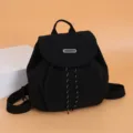 Casual black backpack for women, stylish school rucksack with flap and drawstring closure. - Black