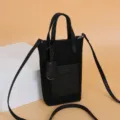 Black mini vertical crossbody phone bag for women with top handle and shoulder strap. - Black