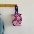 Stylish canvas bucket handbag with elegant pink rose floral print and purple handles. - Pink Purple Rose