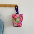 Casual canvas bucket bag with vibrant rose floral print and purple handles for daily use. - Pink and Green Rose