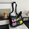 Canvas shoulder bag with colorful cat print, casual student crossbody tote bag for daily commute. - Black