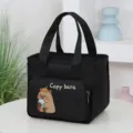 Black canvas lunch handbag with cute capybara print and front pocket main view - Black