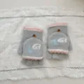 Close-up detail of grey and pink plush half-finger convertible gloves with cute embroidery. - One Size (Women) / Light Gray