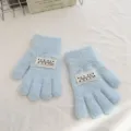 Detailed view of children's solid color cute knit gloves with white label patch. - One Size / Sky Blue