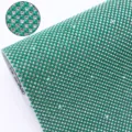 Green resin rhinestone mesh sheet with hot melt adhesive backing for DIY garment crafts. - Green
