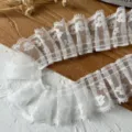 Detailed view of white pleated lace trim, delicate ruffles for DIY sewing and apparel decoration. - 1 Meter Length 4cm Width / White