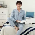 Men's long-sleeve cotton pajama set in light blue with contrast red piping and front buttons. - L / Top And Bottom / Blue