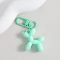 Close-up of a cute mint green balloon dog keychain charm, glossy finish, stylish bag accessory. - Mint Green