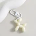 Detailed view of a cute white balloon dog keychain charm, perfect for bags and keys. - Beige