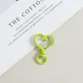 Close-up of a vibrant green heart-shaped lobster clasp snap hook for DIY jewelry crafts. - Light Green
