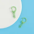 Close-up details of candy-colored zinc alloy DIY keychains with D-buckles and lobster clasps. - Light Green