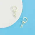 Detailed view of light yellow alloy keychain clasps, showcasing smooth baking paint finish. - Off White